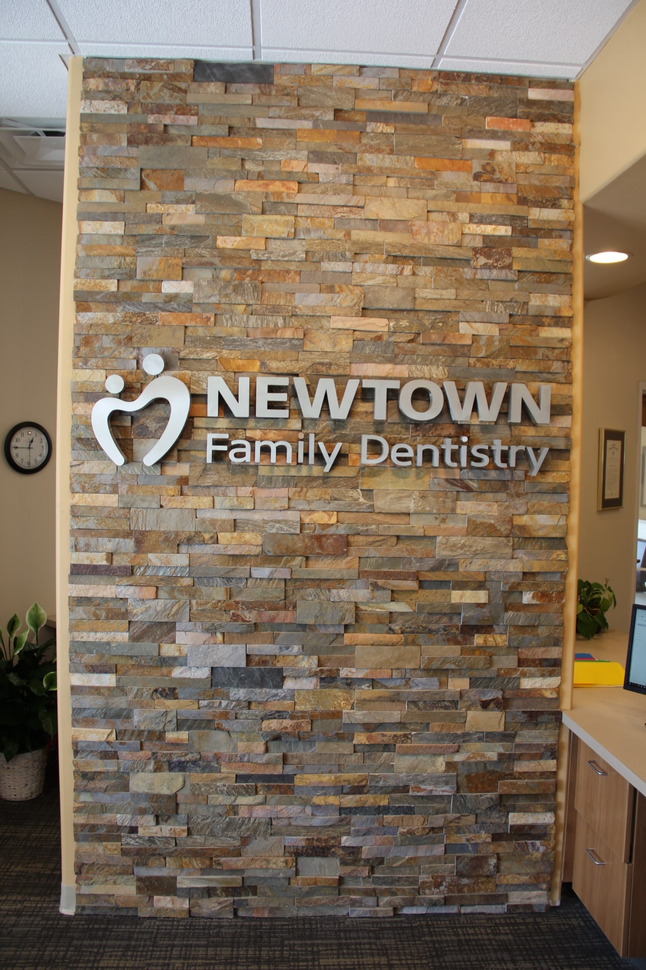 Norstone Ochre Stacked Stone Veneer Rock Panels used on feature wall with signage for dentist practice